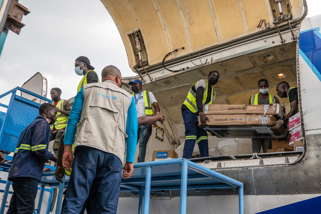 People offload a shipment of more than 15 tons of supplies donated by UNICEF as part of the response to the Ebola virus outbreak at Bunia National Airport in Bunia, Congo, Tuesday, May 19, 2026. (AP Photo/Moses Sawasawa)