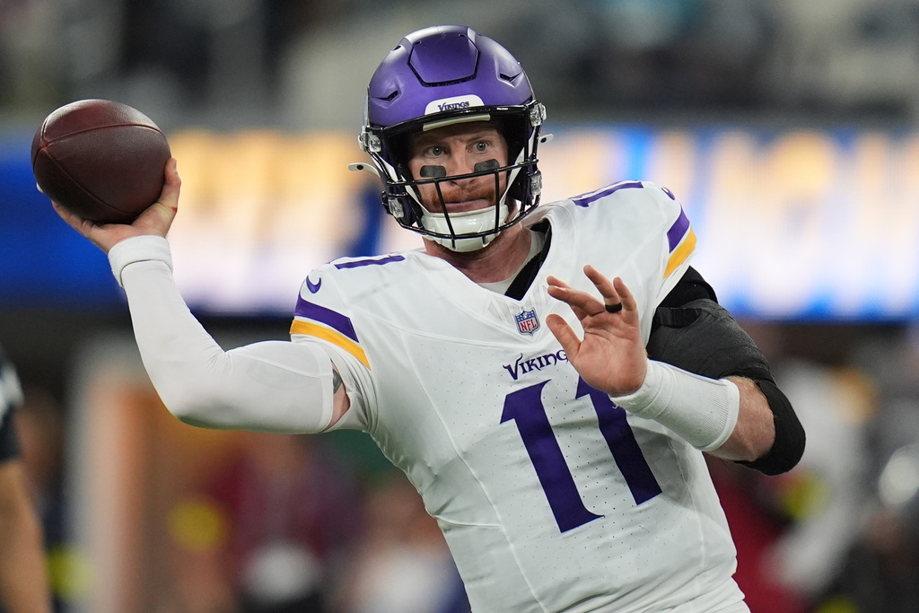 Minnesota Vikings quarterback Carson Wentz (11) passes during the first half of an NFL football game against the Los Angeles Chargers Thursday, Oct. 23, 2025, in Inglewood, Calif. (AP Photo/Gregory Bull)