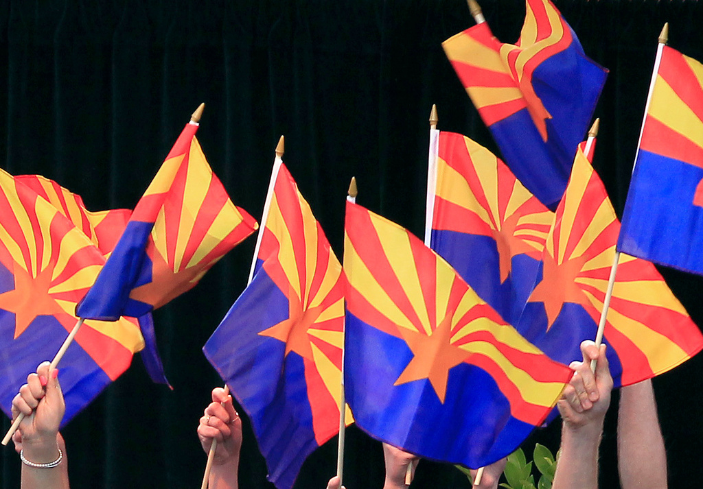FILE - Members of the Arizona State University Barrett Choir wave Arizona state flags during the celebration of the 100th anniversary of Arizona's statehood, Feb. 14, 2012, in Phoenix.(AP Photo/Ross D. Franklin, File)