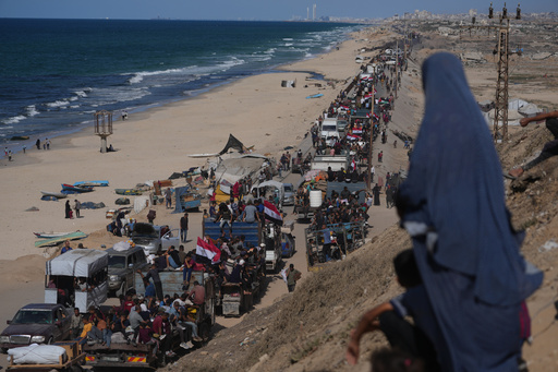 Displaced Palestinians ride on trucks loaded with belongings and wave Egyptian and Palestinian flags as they travel along the coastal road near Wadi Gaza in the central Gaza Strip, moving toward Gaza city, Saturday, Oct. 11, 2025, after Israel and Hamas agreed to a pause in their war and the release of the remaining hostages. (AP Photo/Jehad Alshrafi) Displaced Palestinians ride on trucks loaded with belongings and wave Egyptian and Palestinian flags as they travel along the coastal road near Wadi Gaza in the central Gaza Strip, moving toward Gaza city, Saturday, Oct. 11, 2025, after Israel and Hamas agreed to a pause in their war and the release of the remaining hostages. (AP Photo/Jehad Alshrafi)
