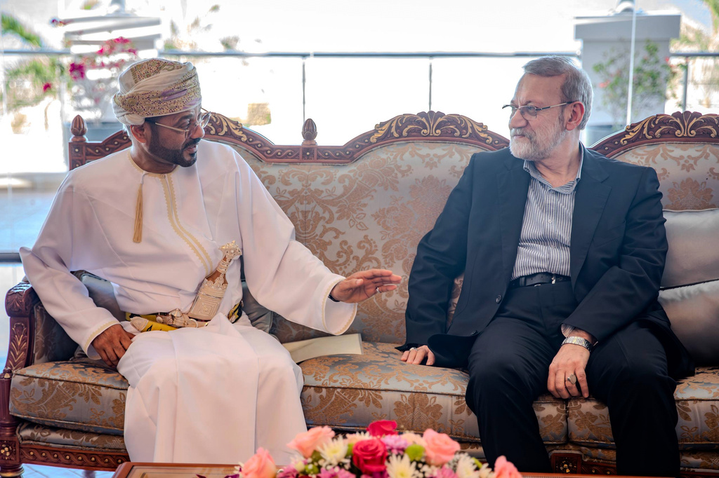 In this photo released by Iran's Supreme National Security Council office, Secretary of the Supreme National Security Council Ali Larijani, right, listens to Omani Foreign Minister Badr al-Busaidi during their meeting in Muscat, Oman, Tuesday, Feb. 10, 2026. (Erfan Kouchari/Iran's Supreme National Security Council Office via AP)