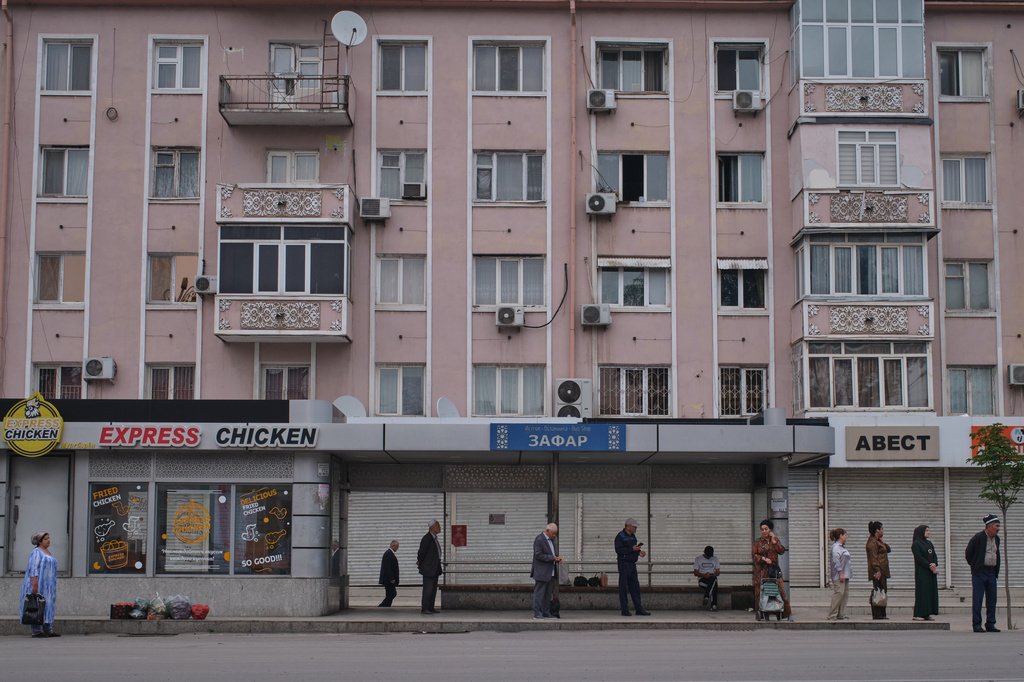 Commuters wait for the bus in Khujand, Tajikistan, Sunday, May 3, 2026. (AP Photo/Jon Orbach)
