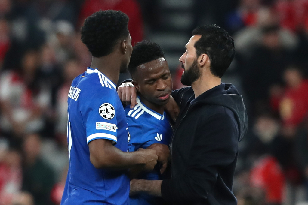 Real Madrid's Vinicius Junior celebrates with Real Madrid's head coach Álvaro Arbeloa the opening goal during a Champions League playoff soccer match between SL Benfica and Real Madrid in Lisbon, Portugal, Tuesday, Feb. 17, 2026. (AP Photo/Pedro Rocha)