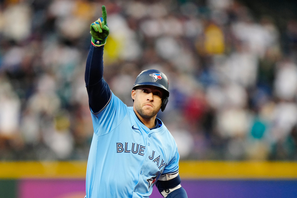 Toronto Blue Jays' George Springer (4) celebrates while rounding the bases after hitting a solo home run against the Seattle Mariners during fourth inning Game 3 American League Championship Series baseball action in Seattle on Wednesday, Oct. 15, 2025. (Frank Gunn/The Canadian Press via AP)