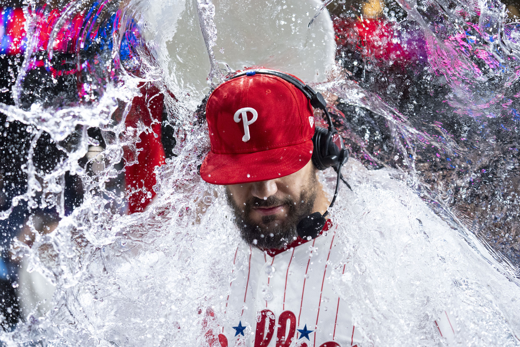 Philadelphia Phillies' Kyle Schwarber, gets doused with water as he is giving a post game interview following a baseball game against the New York Mets, Tuesday, Sep. 9, 2025, in Philadelphia. (AP Photo/Chris Szagola)