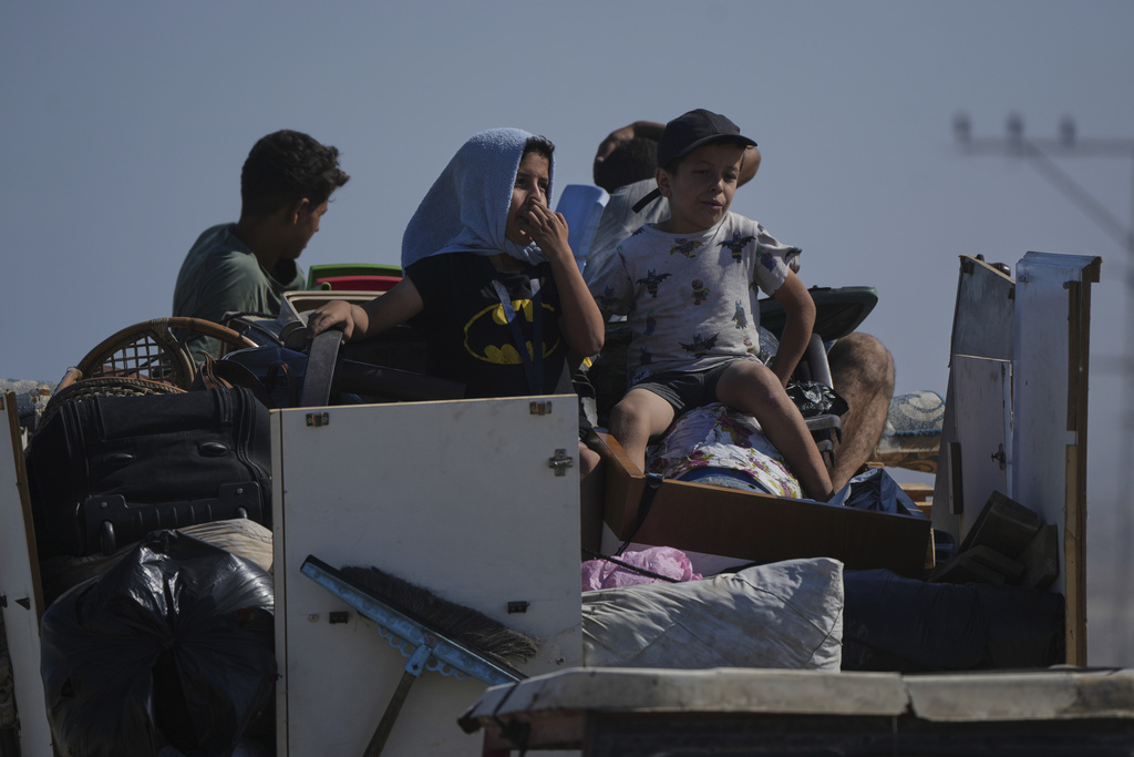 Displaced Palestinians fleeing northern Gaza carry their belongings along the coastal road toward southern Gaza, Tuesday, Sept. 9, 2025, after the Israeli army issued evacuation orders from Gaza City. (AP Photo/Jehad Alshrafi)