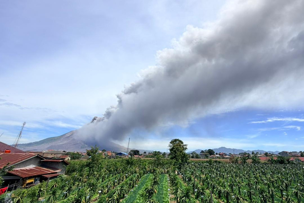 In this photo released by the Geological Agency (Badan Geologi) of Indonesia's Ministry of Energy and Mineral Resources, Mount Sinabung releases volcanic materials into the air during an eruption in Karo, North Sumatra, Indonesia, Monday, Aug. 31, 2026. (Badan Geologi via AP)