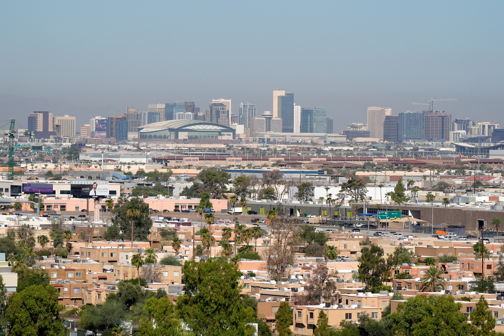 FILE - Condos and apartments give way to the Phoenix skyline Sept. 24, 2024, in Tempe, Ariz. (AP Photo/Ross D. Franklin, File)
