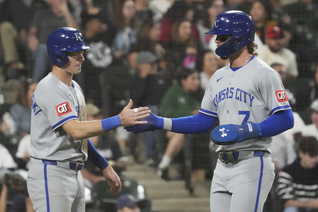 Kansas City Royals' Mike Yastrzemski, left, celebrates with Bobby Witt Jr. after scoring on a two-run single by Vinnie Pasquantino during the fifth inning of a baseball game in Chicago, Wednesday, Aug. 27, 2025. (AP Photo/Nam Y. Huh)