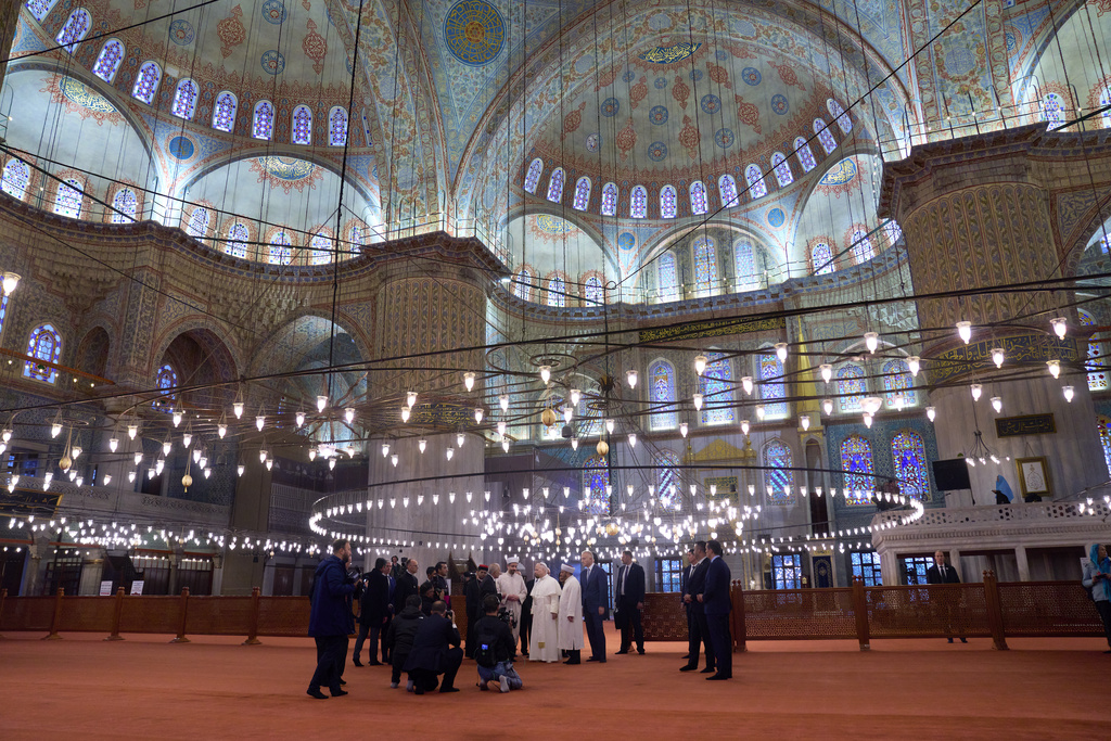 Pope Leo XIV, in the background center, visits the Ottoman-era Sultan Ahmed (Blue) Mosque in Istanbul, Turkey, Saturday, Nov. 29, 2025. (AP Photo/Domenico Stinellis)