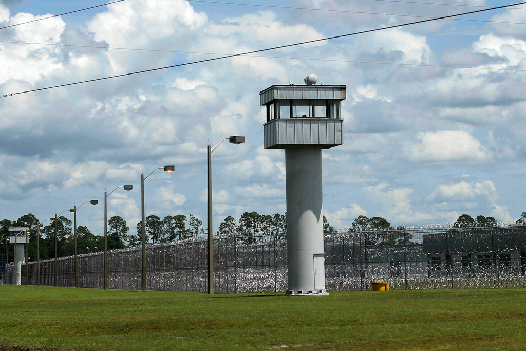 FILE - Fence and towers at the Baker Correctional Institution, Sanderson, Fla., Thursday, Aug. 14, 2025. (AP Photo/Gary McCullough, File)