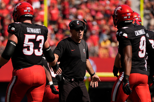 Cincinnati Bearcats head coach Scott Satterfield greets players on the field during the first half of an NCAA college football game against Iowa State , Saturday, Oct. 4, 2025, in Cincinnati. (AP Photo/Carolyn Kaster) Cincinnati Bearcats head coach Scott Satterfield greets players on the field during the first half of an NCAA college football game against Iowa State , Saturday, Oct. 4, 2025, in Cincinnati. (AP Photo/Carolyn Kaster)