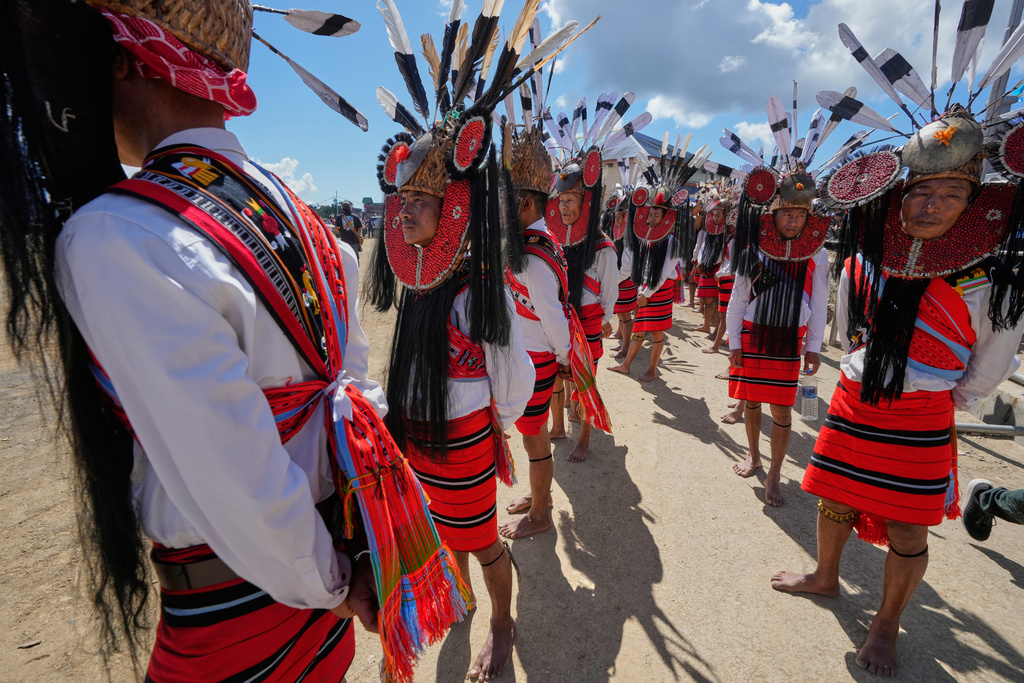 Nagas in traditional attire wait for the arrival of Thuingaleng Muivah, leader of the National Socialist Council of Nagaland (Isak-Muivah), in Ukhrul, in the northeastern Indian state of Manipur, Wednesday, Oct. 22, 2025. (AP Photo/Anupam Nath)
