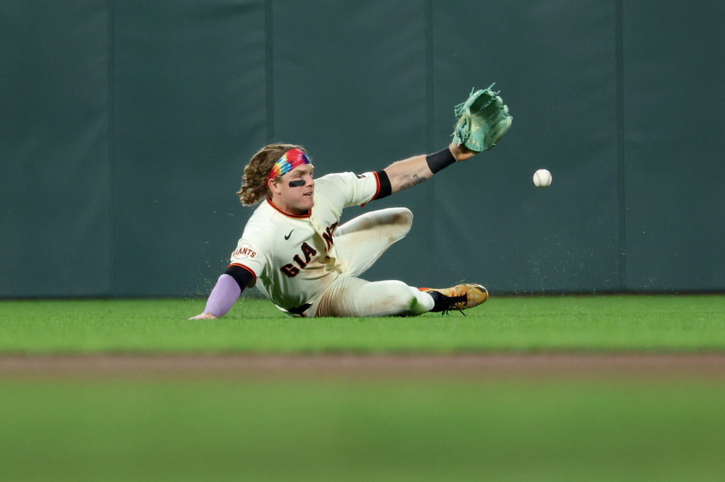 San Francisco Giants' Harrison Bader dives for a single hit by Philadelphia Phillies' Trea Turner during the seventh inning of a baseball game in San Francisco, Monday, April 6, 2026. (AP Photo/Jed Jacobsohn)