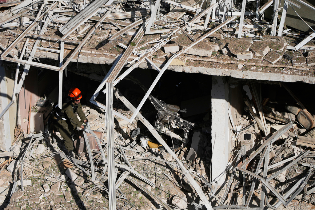An Israeli rescue officer responds at the site of an Iranian missile strike in Tel Aviv, Israel,Tuesday, March 24, 2026. (AP Photo/Ohad Zwigenberg)