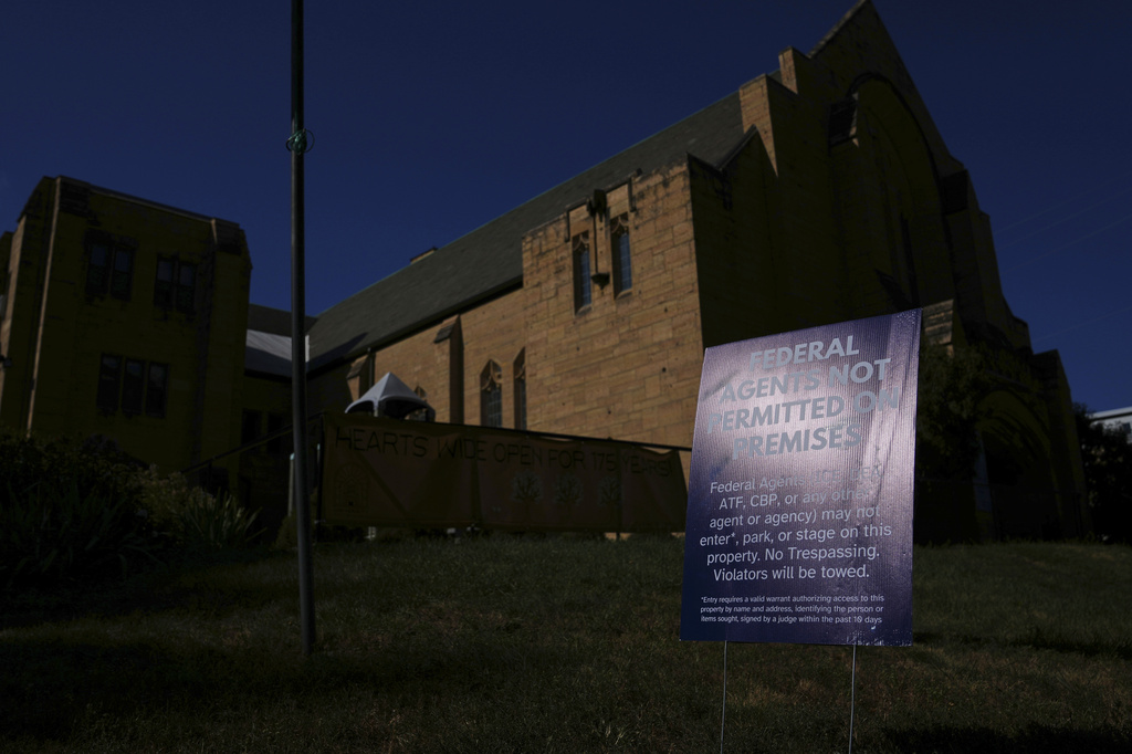 A sign prohibiting federal agents from entering the premises is posted outside University Baptist Church, Friday, Sept. 4, 2026, in Minneapolis. (AP Photo/Ellen Schmidt)