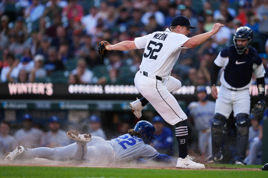 Detroit Tigers pitcher Troy Melton gets the force out at home plate on Kansas City Royals' Carter Jensen (22) on a dropped third strike on Isaac Collins during the first inning of a baseball game Thursday, July 23, 2026, in Detroit. (AP Photo/Paul Sancya)