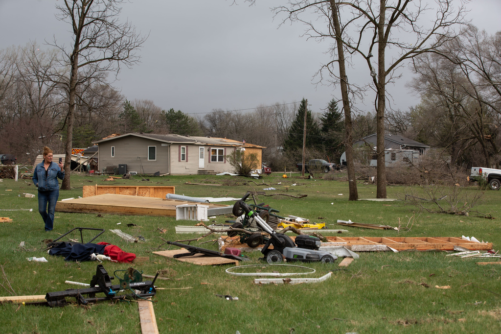 Debris and fallen tree limbs cover the ground after a severe storm that tore through the Upper Midwest on Friday, April 17, 2026, in Rochester, Minn. (Hollie Bennett Piotrowicz via AP)