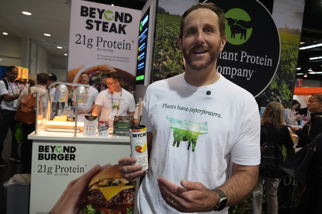 Beyond CEO Ethan Brown, the company's founder, showcases a Beyond Immerse Strawberry Lemonade flavored protein beverage at the Beyond booth as the company is transitioning from Beyond Meat to just Beyond, and to introduce a new line of sparkling plant‑protein drinks at the Natural Products Expo West 2026 at the Anaheim Convention Center in Anaheim, Calif., on Thursday, March 5, 2026. (AP Photo/Damian Dovarganes)