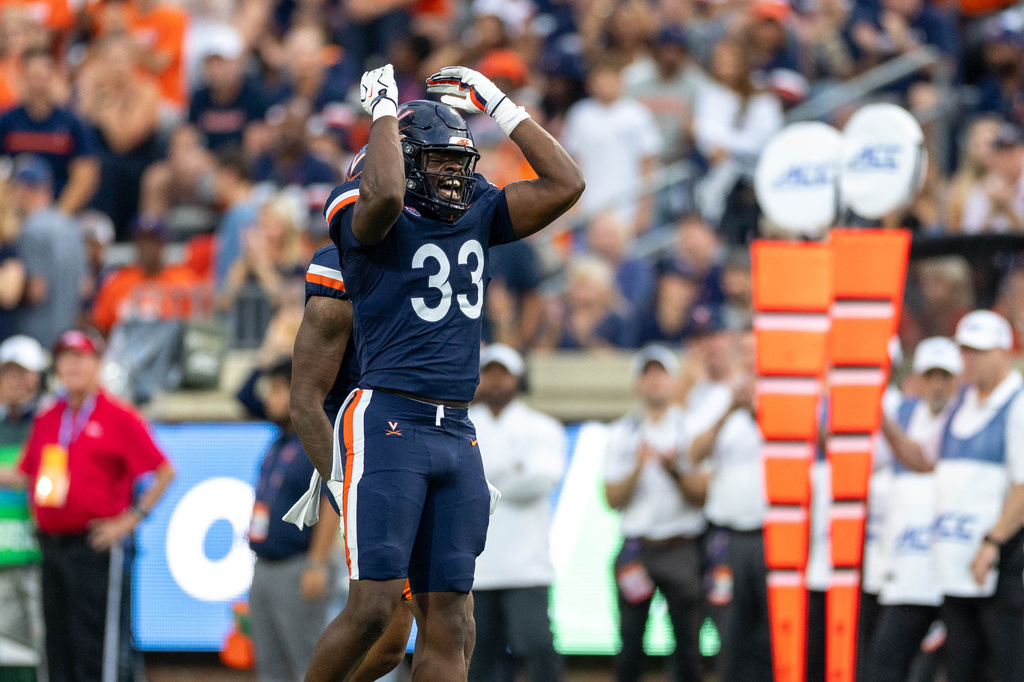 Virginia defensive end Nnanna Anyanwu (33) celebrates during an NCAA college football game against Norfolk State on Friday, Sept. 11, 2026, in Charlottesville, VA. (AP Photo/Mike Kropf)