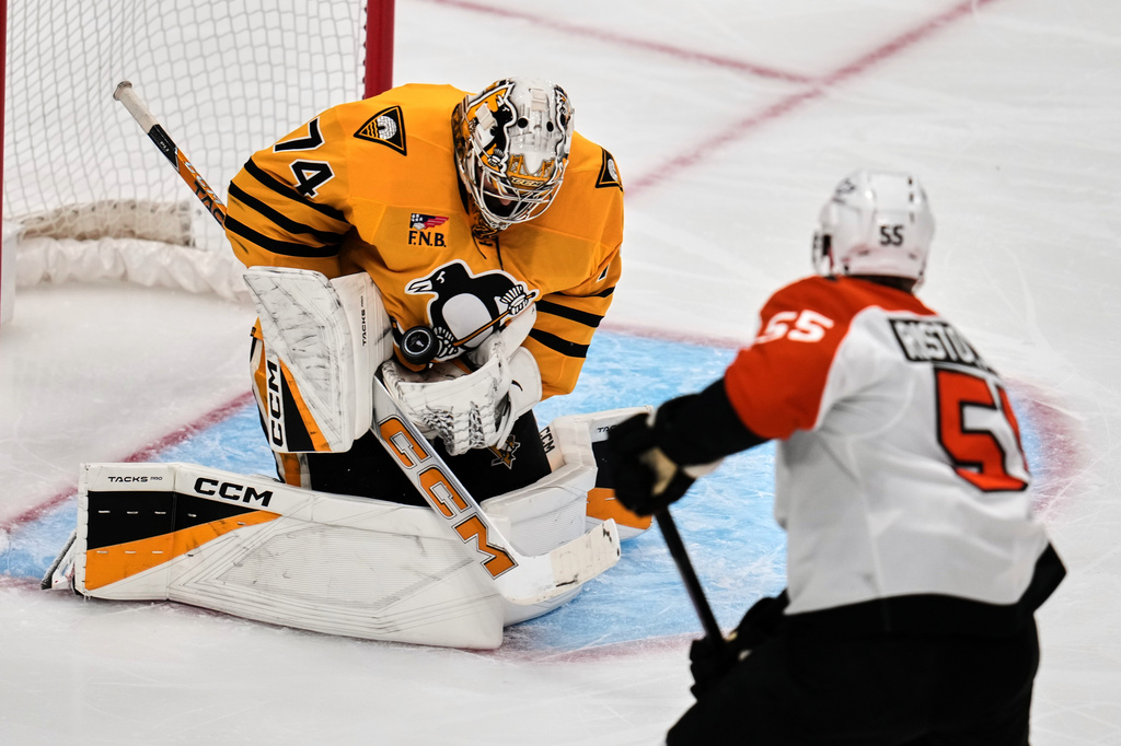 Pittsburgh Penguins goaltender Stuart Skinner (74) blocks a shot by Philadelphia Flyers' Rasmus Ristolainen (55) during the first period of Game 2 in the first round of the NHL Stanley Cup playoffs in Pittsburgh, Monday, April 20, 2026. (AP Photo/Gene J. Puskar)