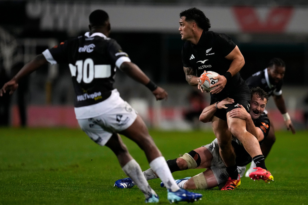 Sharks' Nick Hatton, right, tackles All Blacks' Quinn Tupaea during a friendly rugby match between Sharks and All Blacks, in Durban, South Africa, Tuesday, Aug. 11, 2026. (AP Photo/Themba Hadebe)