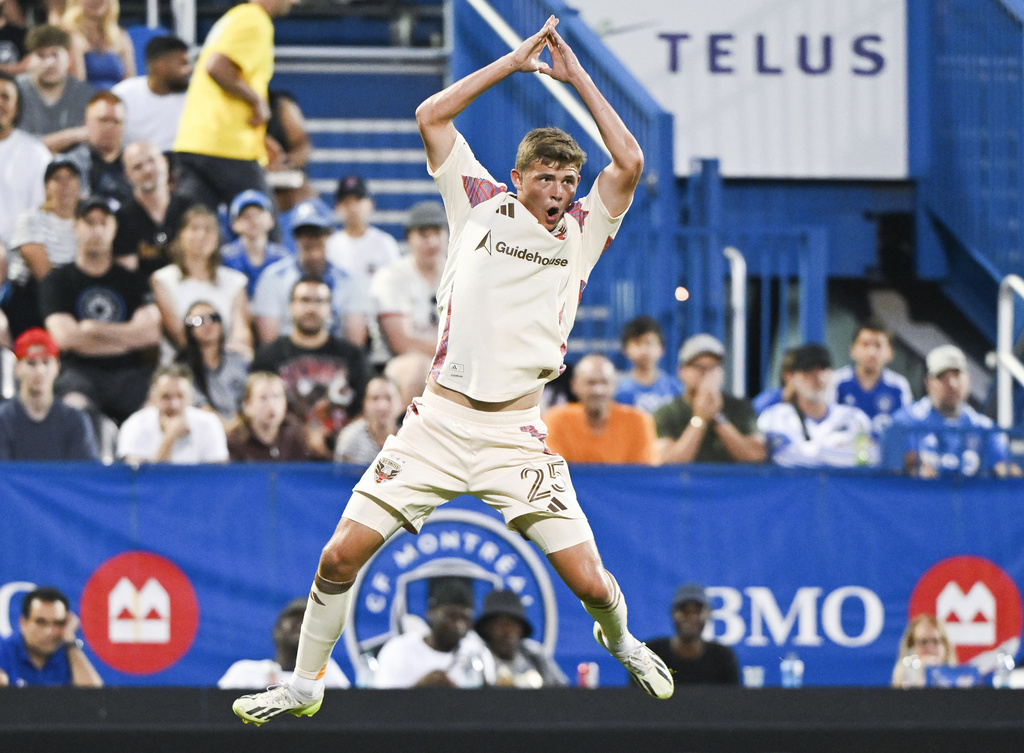 D.C. United's Jackson Hopkins (25) celebrates after scoring against CF Montreal during first-half MLS soccer match action in Montreal, Saturday, Aug. 16, 2025. (Graham Hughes/The Canadian Press via AP)
