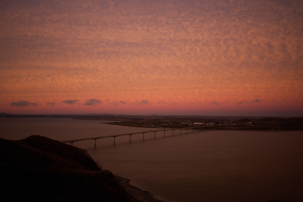 Cars cross a bridge across Lake Sakakawea between Four Bears Village and New Town, N.D., Saturday, Nov. 1, 2025. (AP Photo/John Locher)