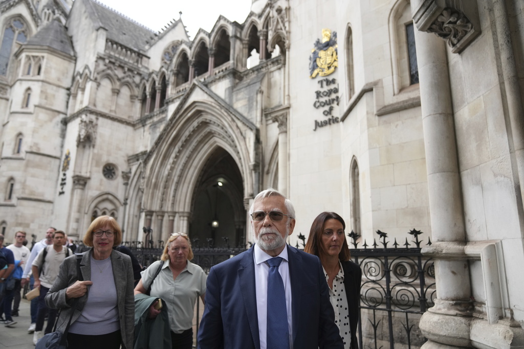 Ken Williamson, Councillor of Epping Forest District Council, second right, speaks to press after the judgment due in Home Office and hotel owner's appeal bids against Epping asylum seeker ruling, at The Royal Courts Of Justice in London, Friday, Aug. 29, 2025. (AP Photo/ Joanna Chan)