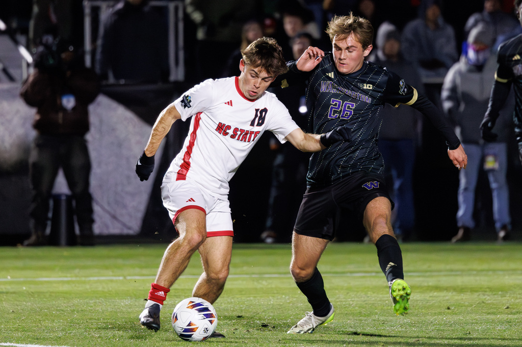 North Carolina State's Taig Healy (10) handles the ball as Washington's Connor Lofy (26) defends during the first half of the NCAA College Cup National Championship soccer final in Cary, N.C., Monday, Dec. 15, 2025. (AP Photo/Ben McKeown)