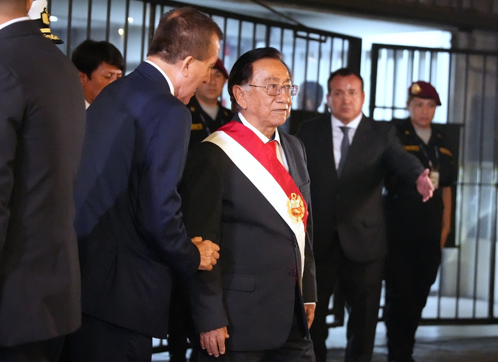 Peru’s new President Jose Maria Balcazar, front right, leaves Congress after lawmakers elected him a day after voting to remove interim President Jose Jeri from office in Lima, Peru, Wednesday, Feb. 18, 2026. (AP Photo/Guadalupe Pardo)