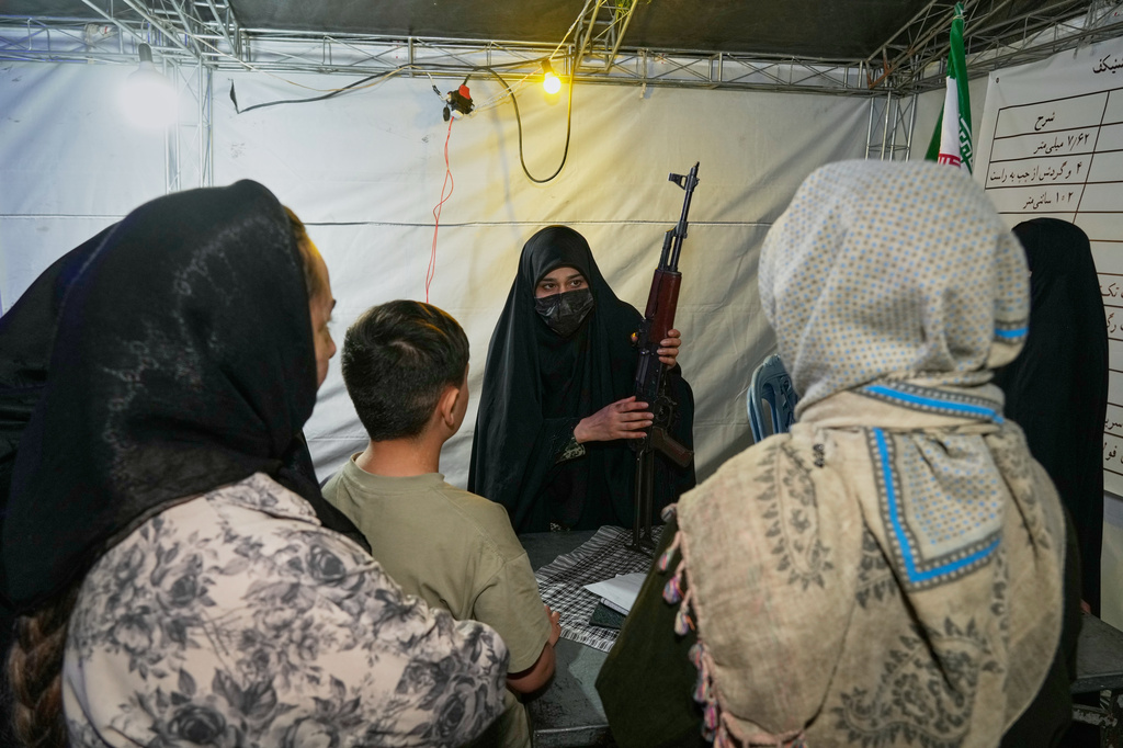 A member of the Revolutionary Guard's volunteer Basij force demonstrates how to handle a Kalashnikov-style assault rifle during a weapons training class in Tehran, Iran, Tuesday, May 19, 2026. (AP Photo/Vahid Salemi)