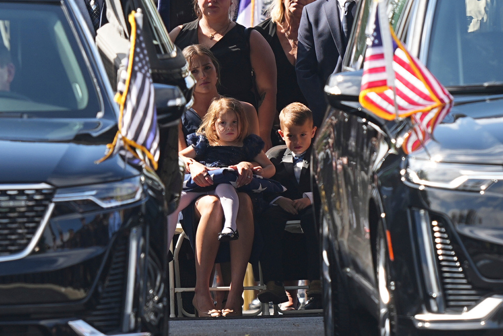 Loved ones look on at the conclusion of funeral services for Northern York County Regional Police detectives Cody Michael Becker, Mark Edward Baker and Isaiah Emenheiser, Thursday, Sept. 25, 2025, in Red Lion, Pa. (AP Photo/Matt Rourke)