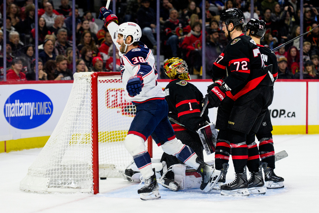 Columbus Blue Jackets' Boone Jenner (38) celebrates his goal on Ottawa Senators goaltender Leevi Merilainen (1) during the first period of an NHL hockey game, in Ottawa, Ontario, Monday, Dec. 29, 2025. (Spencer Colby/The Canadian Press via AP)
