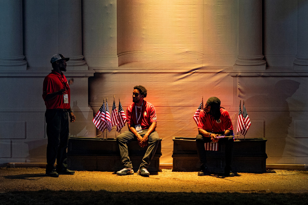 Workers rest after the Great American State Fair on the National Mall closed for the day, Monday, June 29, 2026, in Washington. (AP Photo/Jen Golbeck)