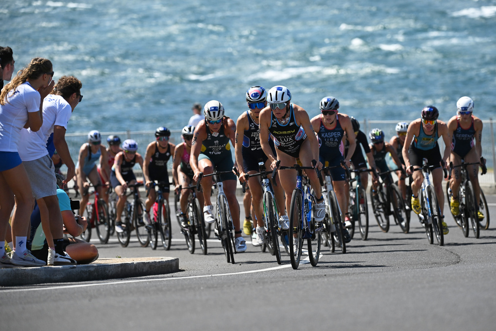 Participants compete in the bike leg of the Elite Women's final at the World Triathlon Championships in Wollongong, Australia, Sunday, Oct. 19, 2025. (Dean Lewins/AAPImage via AP)
