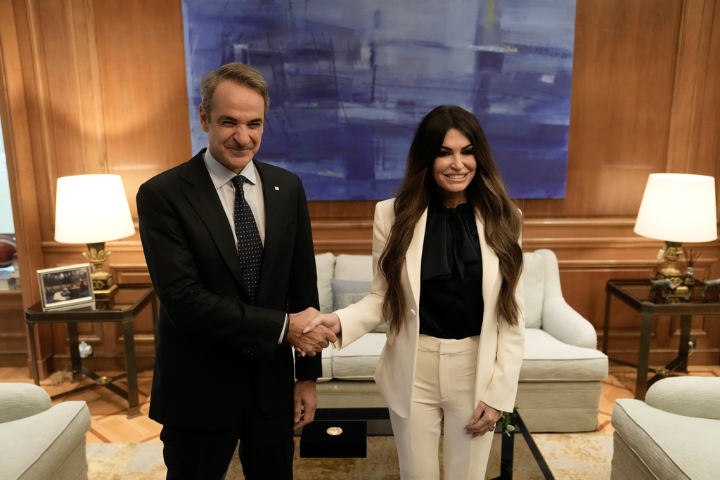 Greece's Prime Minister Kyriakos Mitsotakis, left, welcomes Kimberly Guilfoyle, the new U.S. Ambassador to Greece, at Maximos Mansion in Athens, Greece, Wednesday, Nov. 5, 2025. (AP Photo/Thanassis Stavrakis)