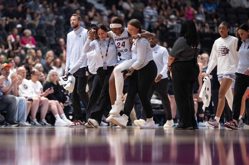 Toronto Tempo's Aneesah Morrow (24) is helped off the court during the first half of a WNBA basketball game against the Portland Fire in Vancouver, British Columbia, Friday, Aug. 21, 2026. (Ethan Cairns/The Canadian Press via AP)