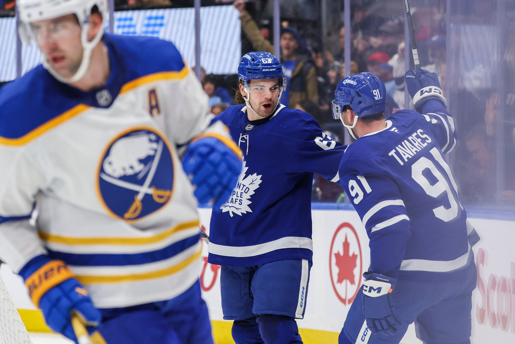 Toronto Maple Leafs teammates John Tavares (91) and Matias Maccelli celebrate a goal during the second period of an NHL hockey game in Toronto, Saturday, Oct. 25, 2025. (Nick Iwanyshyn/The Canadian Press via AP)