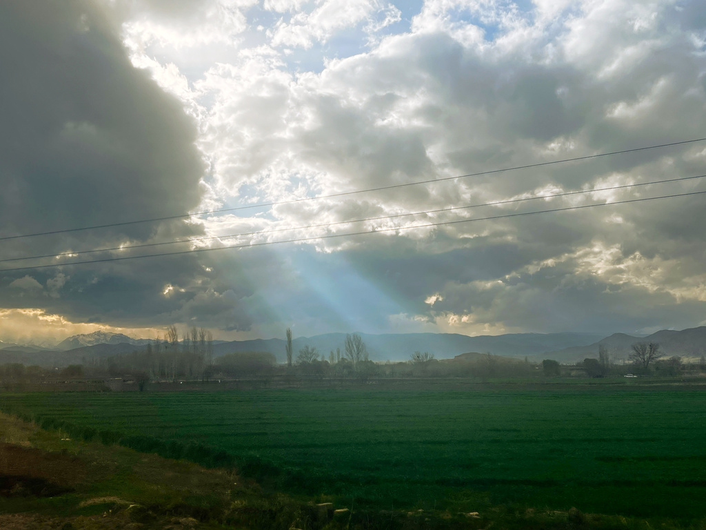 Rays of sunlight break through clouds over a field on Road 11, near the Turkey border crossing, in Razi, Iran, Thursday, April 9, 2026. (AP Photo/Francisco Seco)
