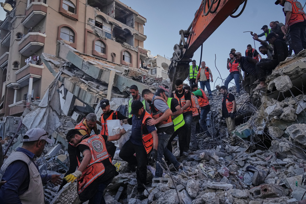 Palestinian civil defense crews carry a body from the rubble of a collapsed building that housed displaced Palestinians and was heavily damaged during the Israel-Hamas war, in Gaza City, Wednesday, Sept. 16, 2026. (AP Photo/Jehad Alshrafi)