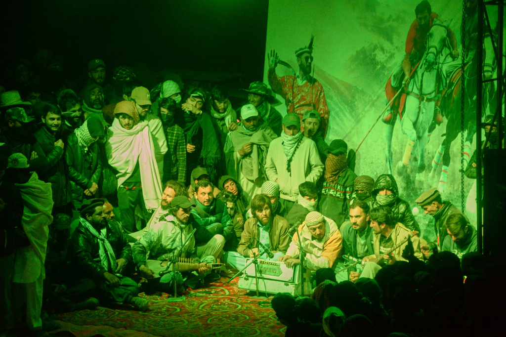 Spectators listen to a folk music performance at a temporary tent village set up for three-day annual Shandur Polo Festival in Shandur Pass, in the Ghizer district of Gilgit-Baltistan, northern Pakistan, Thursday, June 11, 2026. (AP Photo/Zubair Abbasi)