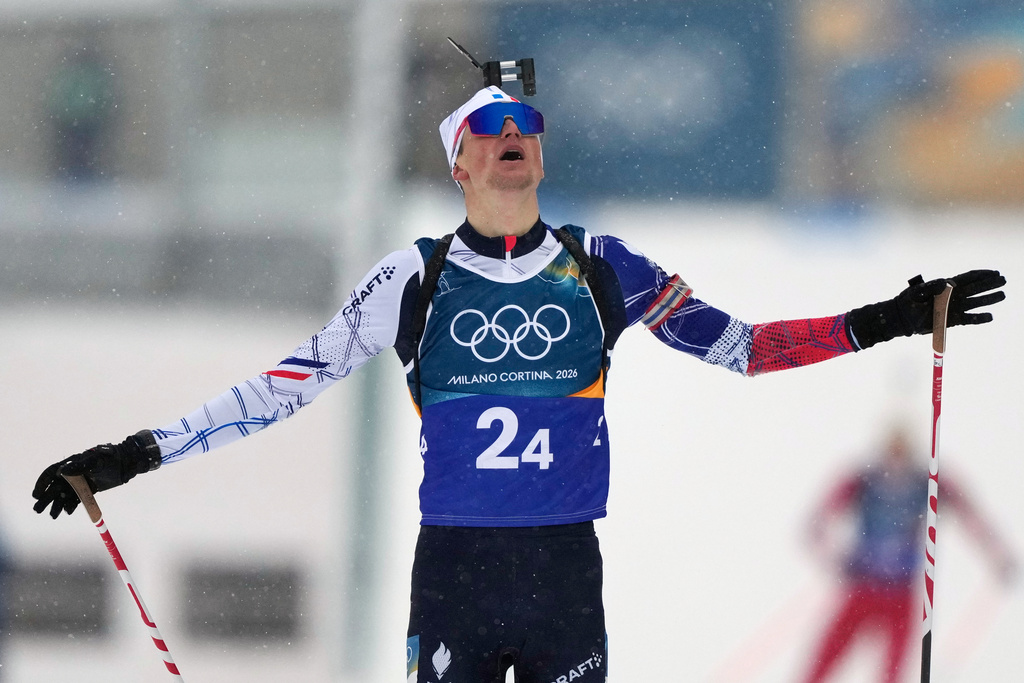Eric Perrot, of France, reacts as he crosses the finish line to win gold in the men's 4x7.5-kilometer relay biathlon race at the 2026 Winter Olympics in Anterselva, Italy, Tuesday, Feb. 17, 2026. (AP Photo/Mosa'ab Elshamy)