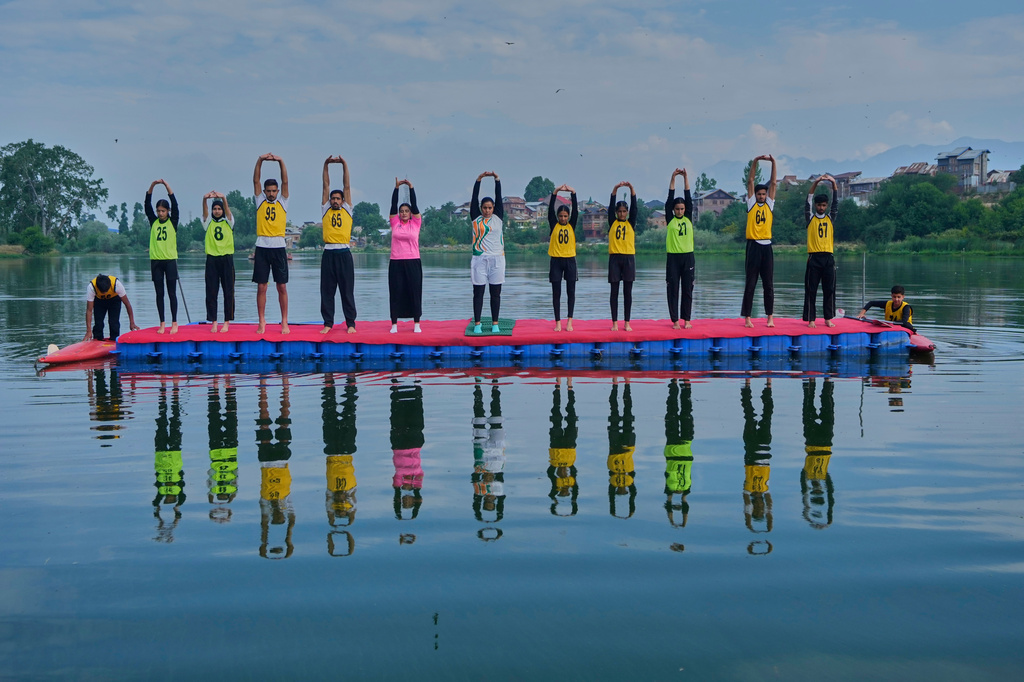Participants perform yoga during an International Yoga Day event at Pokhrabal Lake in Srinagar, Indian controlled Kashmir, Sunday, June 21, 2026. (AP Photo/Mukhtar Khan)