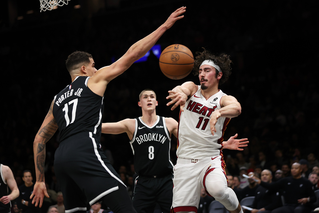 Miami Heat forward Jaime Jaquez Jr. (11) passes the ball around Brooklyn Nets forward Michael Porter Jr. (17) during the first half of an NBA basketball game, Thursday, Dec. 18, 2025, in New York. (AP Photo/Heather Khalifa)