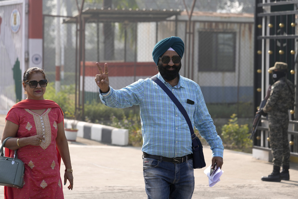 FILE -An Indian Sikh pilgrims flashes victory signs as they enter into Pakistan through Kartarpur border crossing point to attend the birth anniversary of their first Sikh guru, Guru Nanak Dev, at his shrine of Gurdwara Darbar Sahib, in Kartarpur, Pakistan, Nov. 19, 2024. (AP Photo/Anjum Naveed), File)