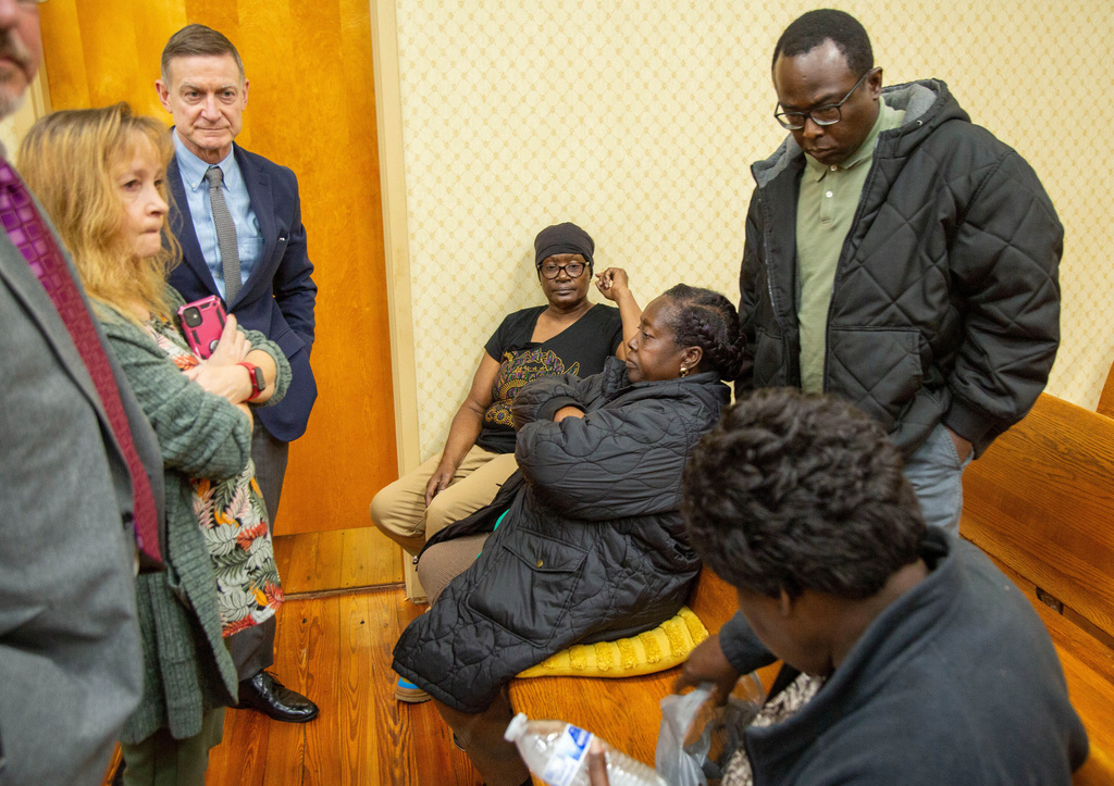 Eurie Martin’s sister Helen Gilbert, third from right, with family and Prosecutor George Lipscomb, third from left, and his team, sit and wait after a pair of questions for from the jury deliberating murder charges against the three former Washington County Sheriff’s deputies accused of killing Martin on Thursday, Nov. 20, 2025 in Sandersville, Ga. (Grant Blankenship/Georgia Public Broadcasting via AP)