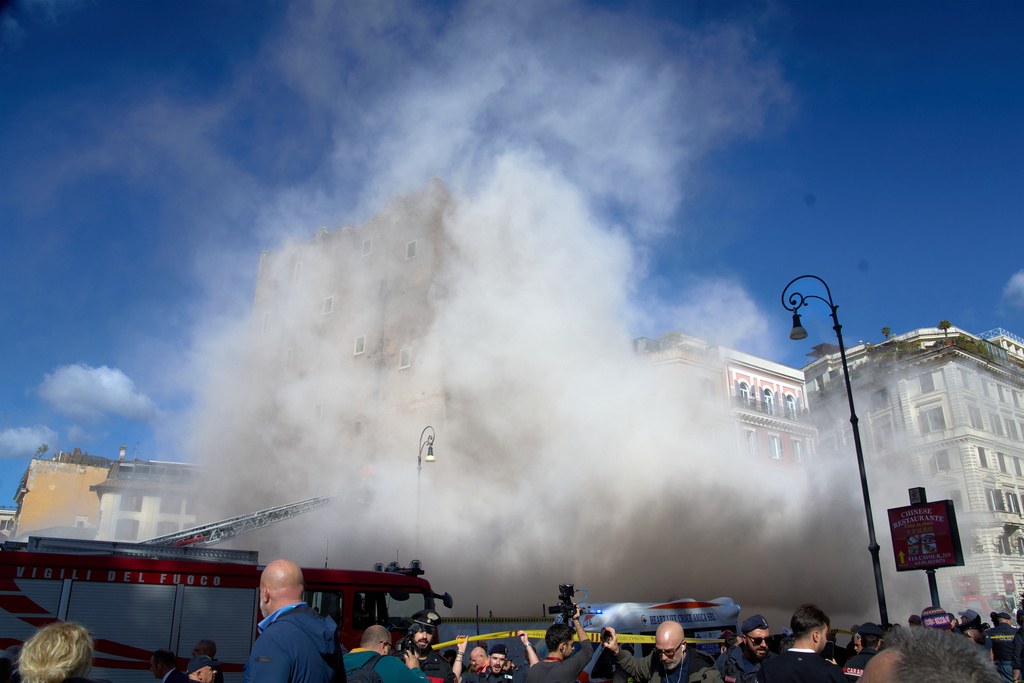 The medieval tower Torre dei Conti near the Roman Forum is engulfed by a cloud of debris from a second collapse after it had partially collapsed during renovation works, in Rome, Italy, Monday, Nov. 3, 2025. (AP Photo/Domenico Stinellis)