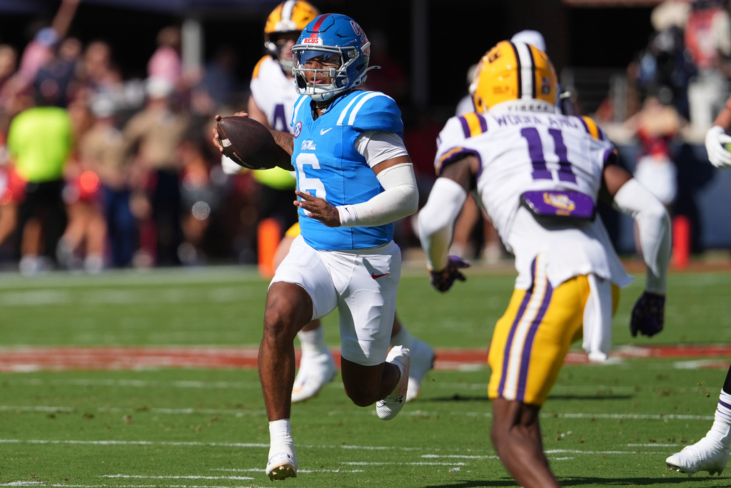Mississippi quarterback Trinidad Chambliss (6) runs for a first down while pursued by LSU cornerback PJ Woodland (11) during the first half of an NCAA college football game in Oxford, Miss., Saturday, Sept. 27, 2025. (AP Photo/Rogelio V. Solis)