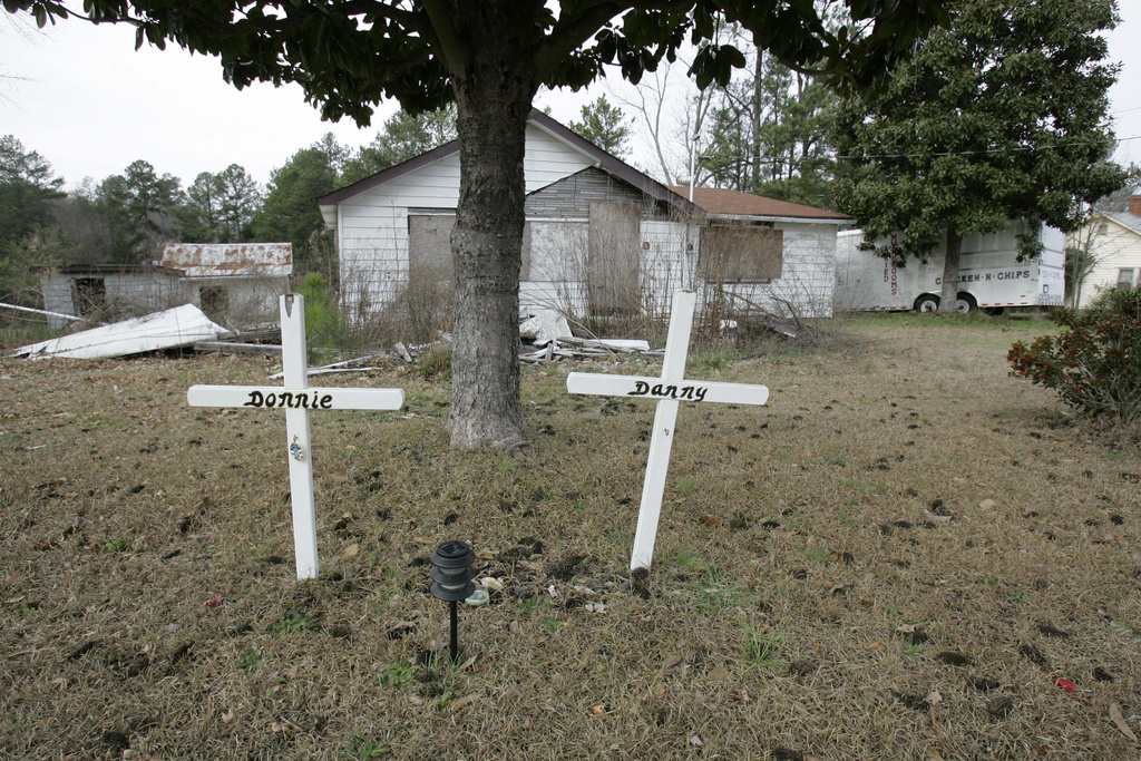 FILE- Two crosses still stand in the front yard Tuesday, Jan. 23, 2007, where Sheriff's Sgt. Danny Wilson and constable Donnie Ouzts were shot outside the house of Arthur and Rita Bixby in Abbeville, S.C. (AP Photo/Mary Ann Chastain, File)